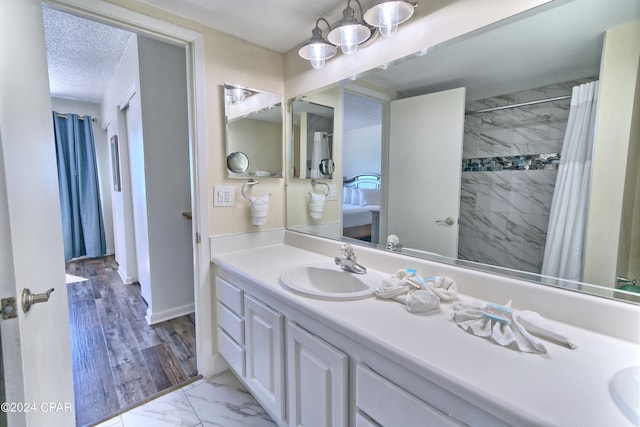 bathroom featuring a shower with shower curtain, wood-type flooring, and vanity