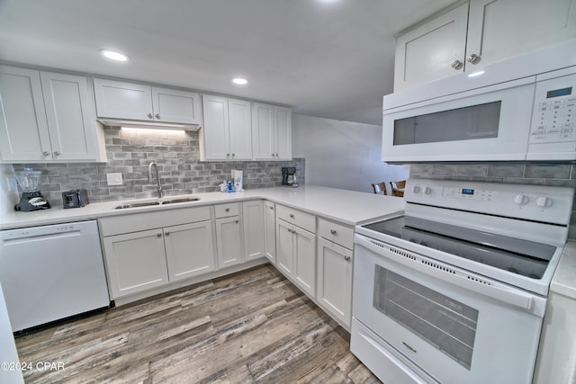 kitchen featuring hardwood / wood-style floors, white appliances, white cabinetry, and sink