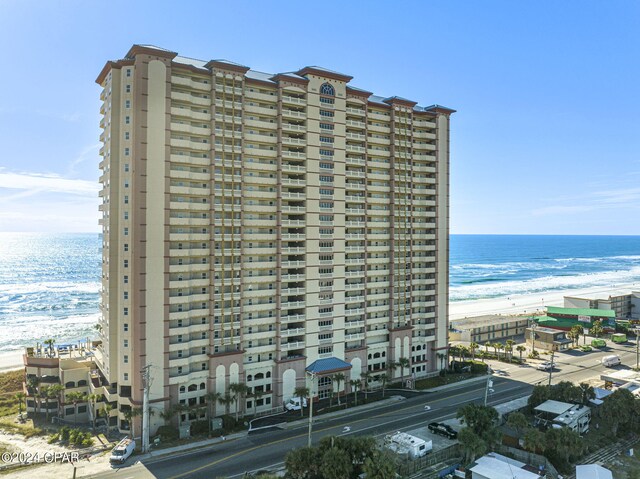 view of property with a view of the beach and a water view