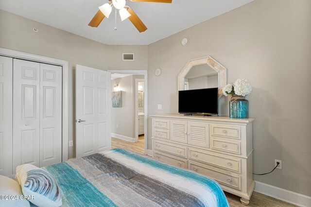 bedroom with light hardwood / wood-style floors, a closet, and ceiling fan