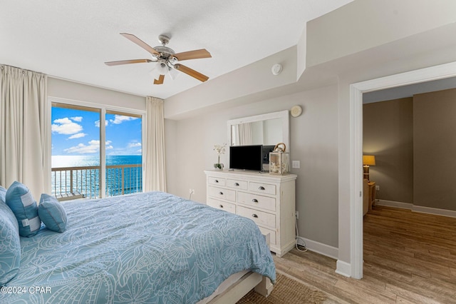 bedroom with access to outside, light wood-type flooring, and ceiling fan