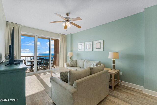 living room with ceiling fan and hardwood / wood-style floors