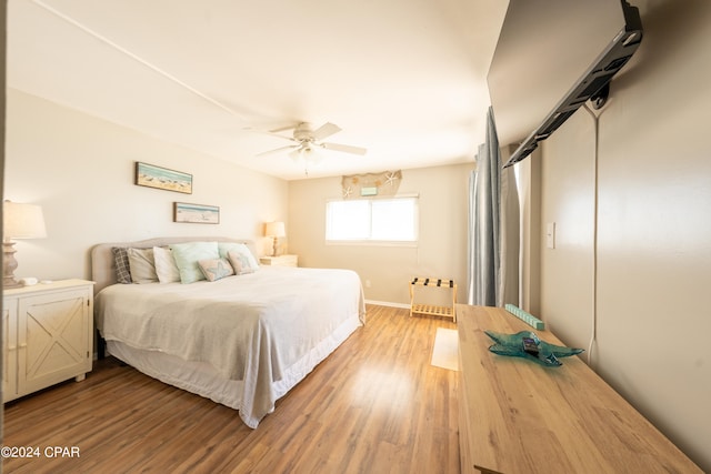 bedroom with ceiling fan and hardwood / wood-style flooring