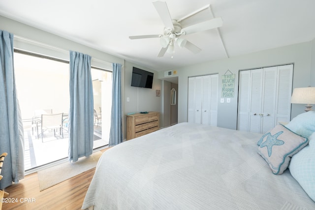 bedroom featuring hardwood / wood-style floors, multiple windows, ceiling fan, and access to exterior