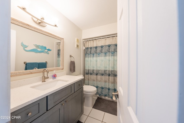 bathroom featuring toilet, tile floors, and vanity