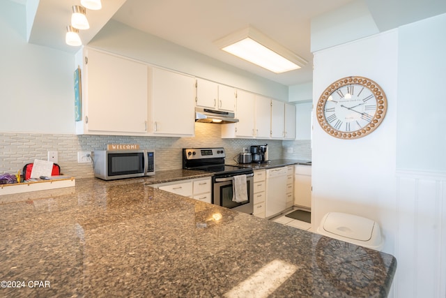 kitchen with stainless steel appliances, light tile flooring, tasteful backsplash, dark stone counters, and white cabinetry