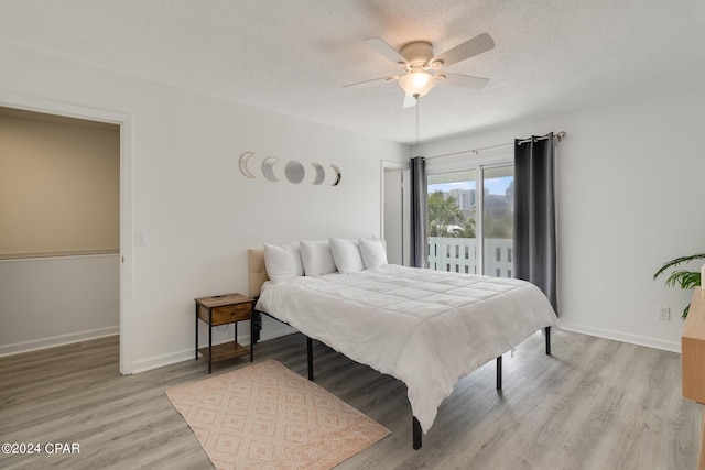 bedroom featuring ceiling fan, a textured ceiling, and light wood-type flooring