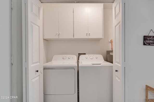 laundry room featuring cabinets and independent washer and dryer