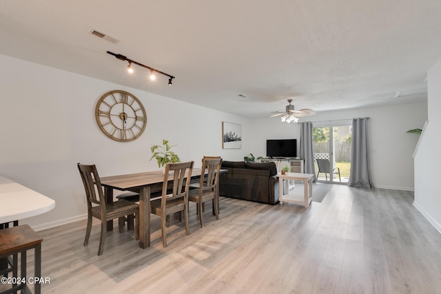 dining area featuring ceiling fan, light hardwood / wood-style floors, and track lighting