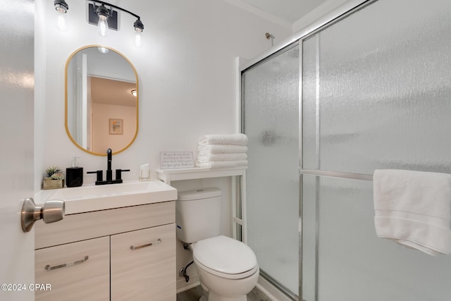 bathroom featuring an enclosed shower, vanity, toilet, and crown molding