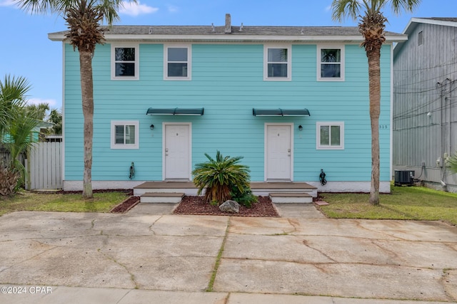 colonial-style house with central AC unit