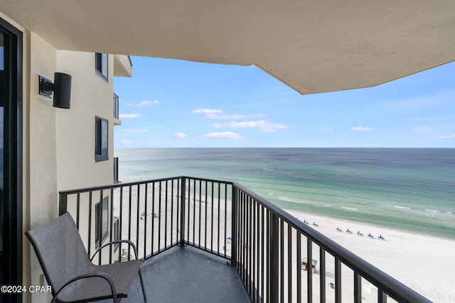 balcony featuring a water view and a view of the beach