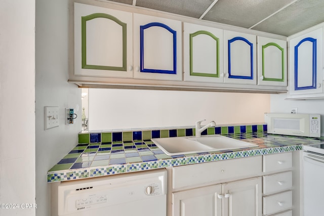 kitchen featuring white cabinetry, white appliances, and sink