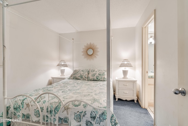 carpeted bedroom featuring a textured ceiling