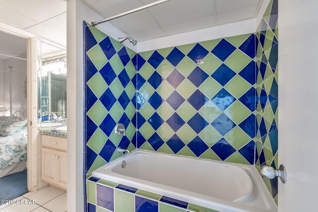 bathroom featuring tiled shower / bath combo, tile floors, and vanity