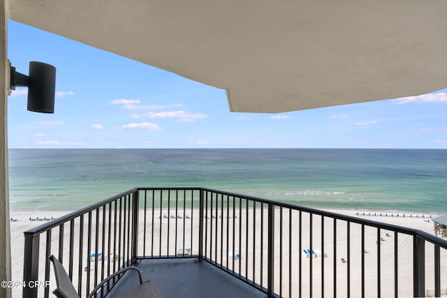 balcony featuring a water view and a view of the beach