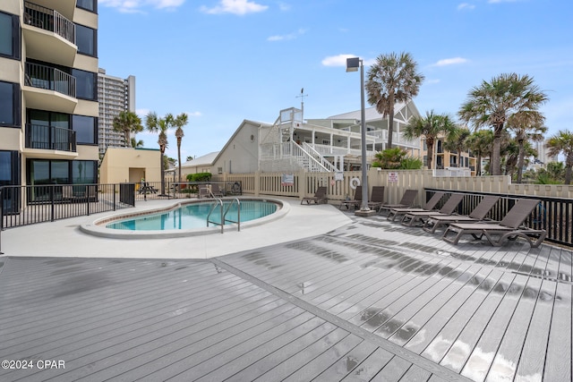 view of swimming pool with a deck