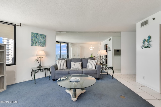 living room featuring light carpet and a textured ceiling