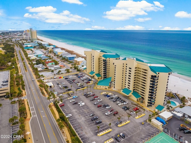 birds eye view of property with a water view and a view of the beach