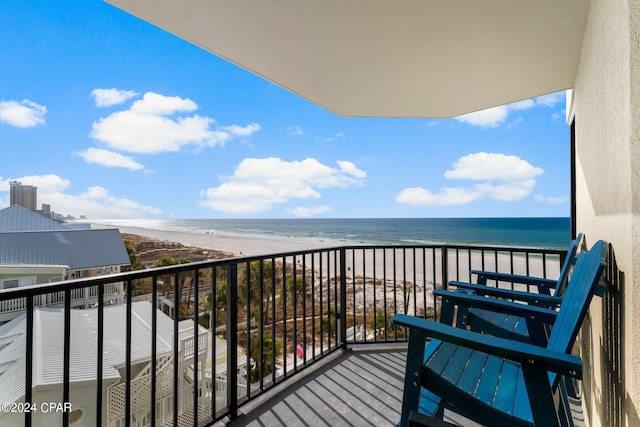 balcony featuring a water view and a beach view