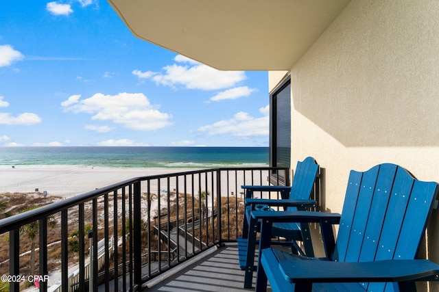 balcony with a water view and a beach view