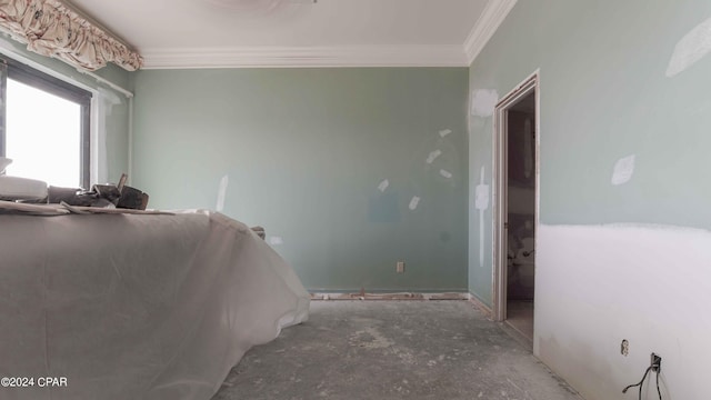 bedroom featuring ornamental molding and concrete floors