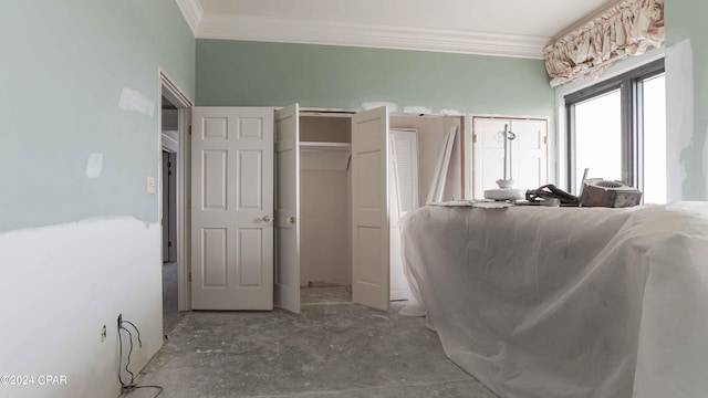 interior space featuring concrete floors and ornamental molding