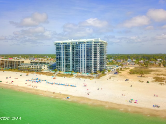 bird's eye view featuring a water view and a beach view