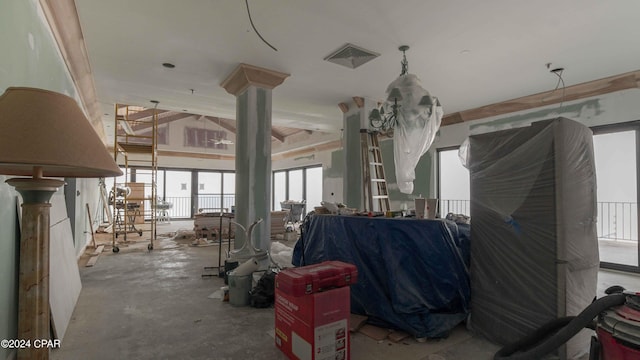 miscellaneous room featuring concrete floors and decorative columns