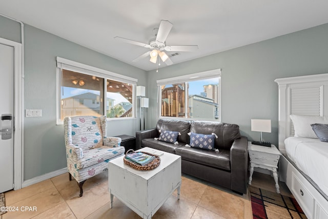 tiled living room with ceiling fan