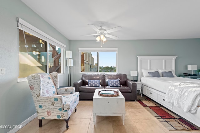 bedroom featuring ceiling fan and light tile floors