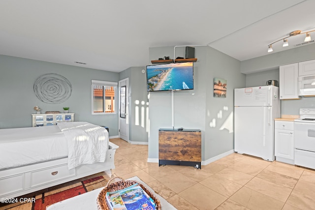 tiled bedroom with track lighting and white fridge