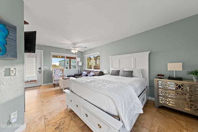 tiled bedroom featuring ceiling fan