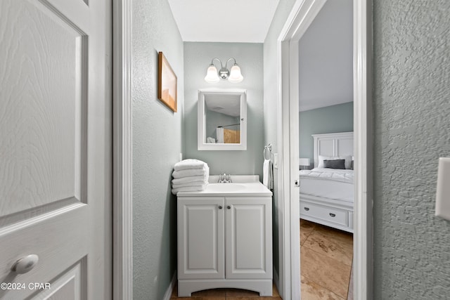 bathroom with tile floors and vanity with extensive cabinet space