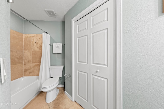 bathroom with tile flooring, a textured ceiling, shower / bath combo with shower curtain, and toilet