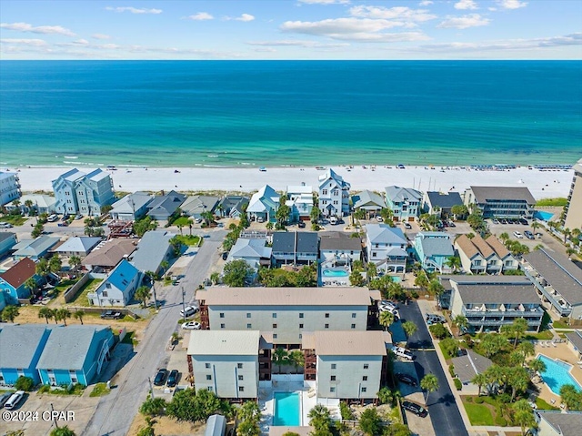 birds eye view of property with a water view and a view of the beach