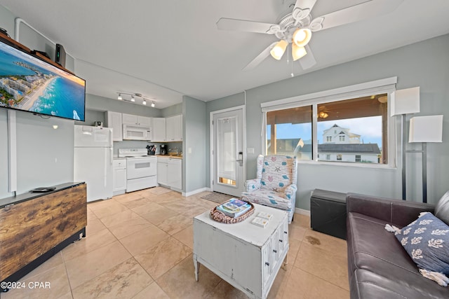 living room with rail lighting, ceiling fan, and light tile floors