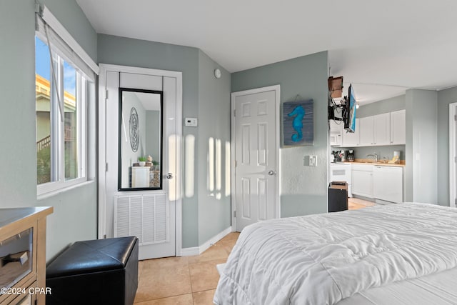 bedroom featuring sink and light tile floors