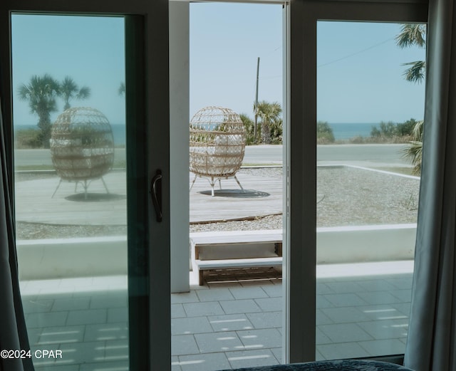 doorway to outside with a water view