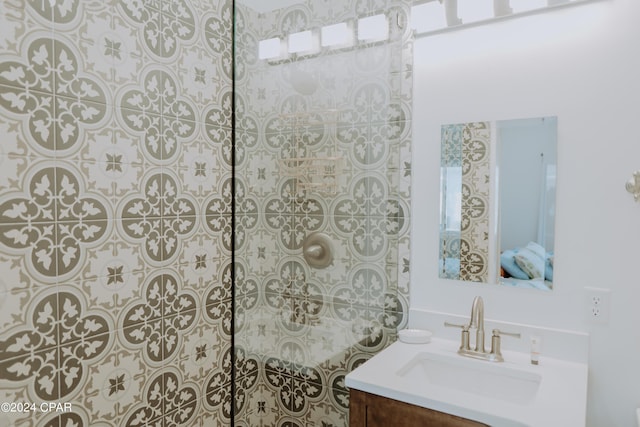 bathroom featuring walk in shower and vanity