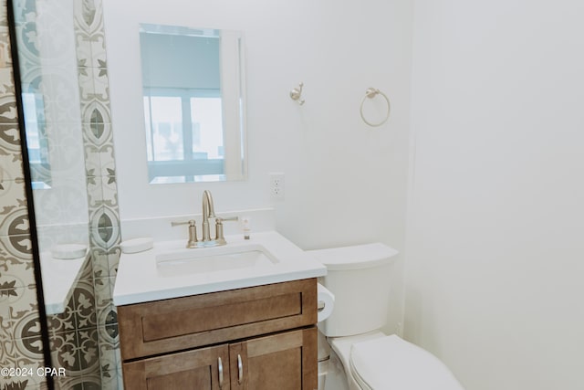 bathroom with toilet and vanity