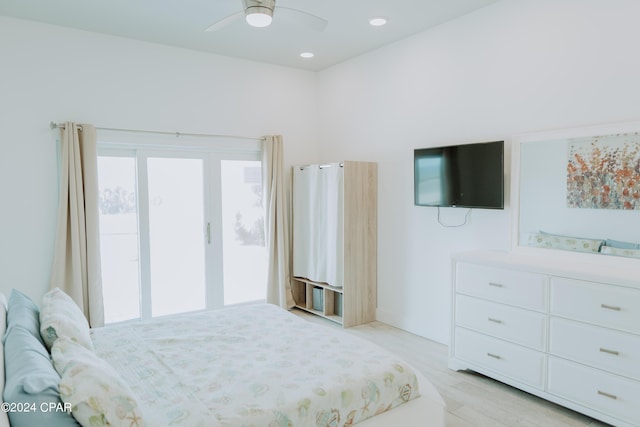 bedroom featuring access to exterior, ceiling fan, multiple windows, and light wood-style flooring