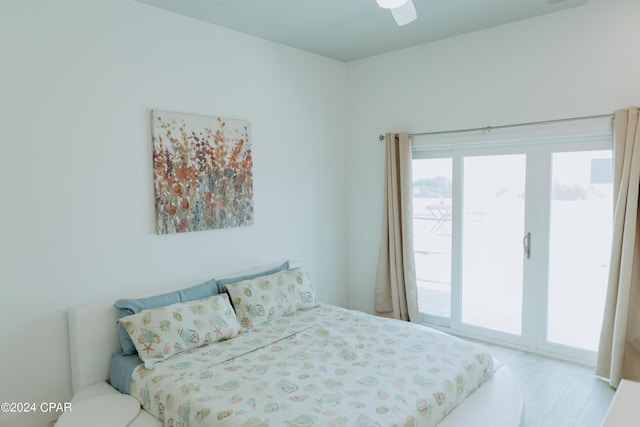 bedroom featuring access to exterior, a ceiling fan, and light wood-style floors