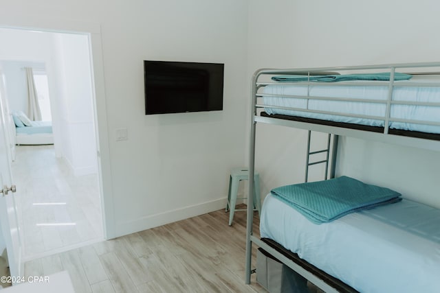 bedroom featuring light wood-style flooring and baseboards