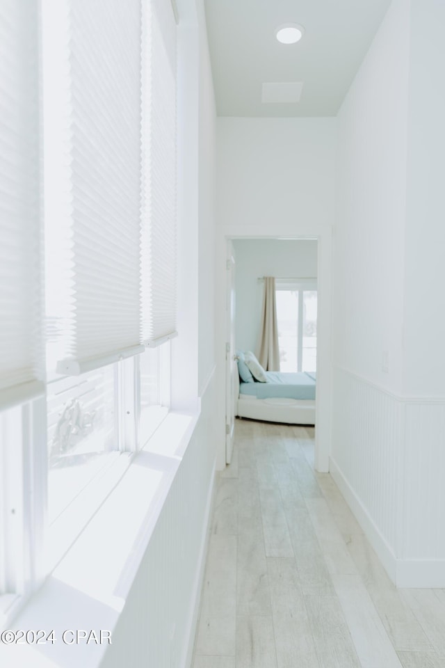 hall featuring a wainscoted wall