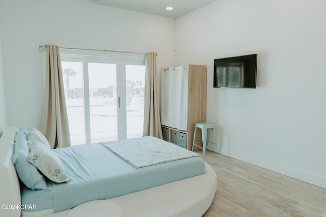 bedroom featuring access to exterior, recessed lighting, wood finished floors, and baseboards