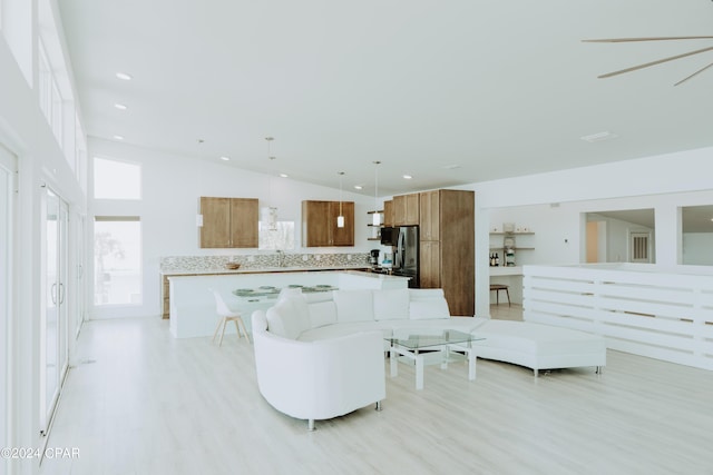 living room featuring light wood-style flooring and recessed lighting