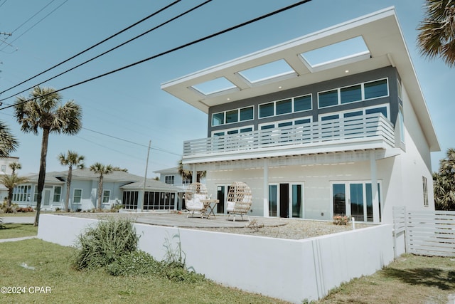 rear view of house with fence, a patio, and stucco siding