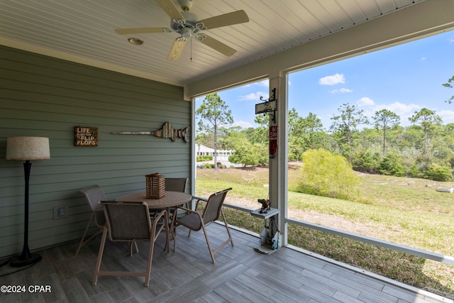 wooden deck with a yard and ceiling fan