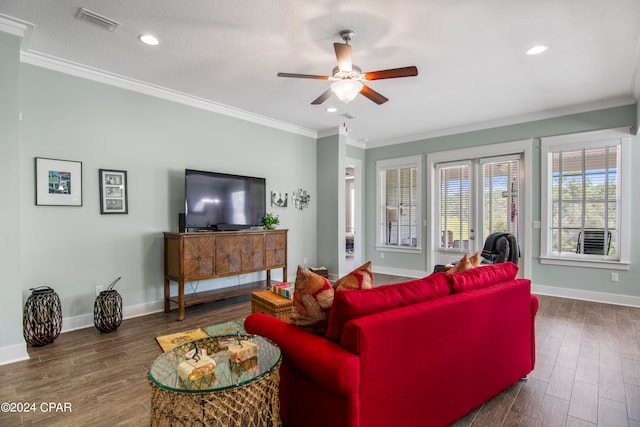 living room featuring dark wood-type flooring, ornamental molding, ceiling fan, and a textured ceiling